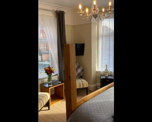 a room with a window and a chair and a table at The Whalebone Arch in Whitby