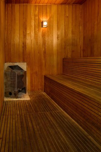 a room with a wood paneled room with a fireplace at Hotel Serra da Estrela in Campos do Jordão