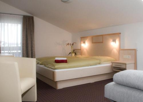 a bedroom with a large bed in a room at Pension Dorfplatzl in Fusch an der Glocknerstraße