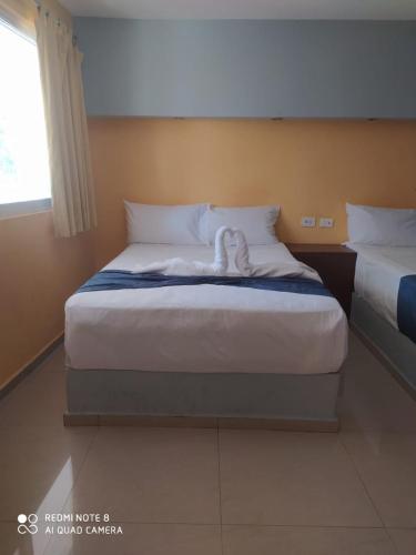 Postel nebo postele na pokoji v ubytování Hotel Posada Maya