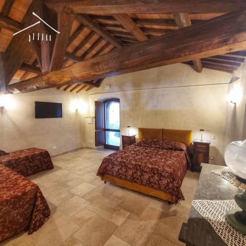 a large room with two beds and a tv at Casa Argenti in Arrone