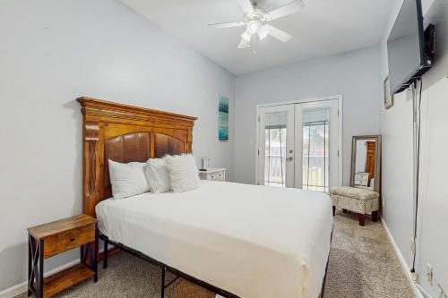 a bedroom with a bed and a ceiling fan at Pura Vida Unit A in South Padre Island