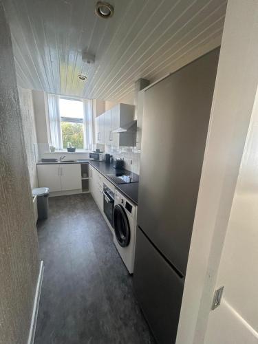 Η κουζίνα ή μικρή κουζίνα στο Hillhead Apartment