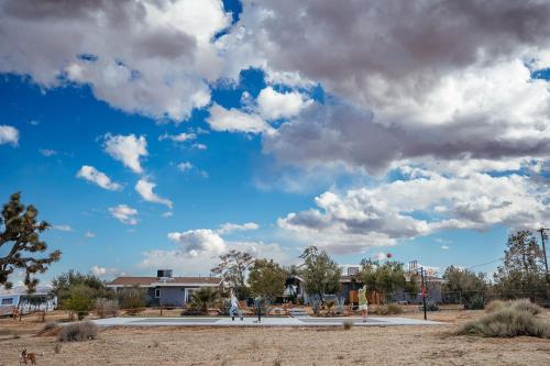 a blue sky with clouds in a park at Sunset Grove By The Cohost Company in Yucca Valley