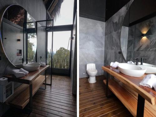 a bathroom with two sinks and a mirror at La Cima Eco Hotel in Buenavista