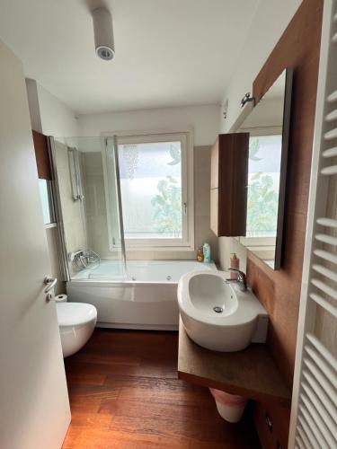 un bagno con vasca, lavandino e vasca da bagno di Appartamento Da Mario a Udine