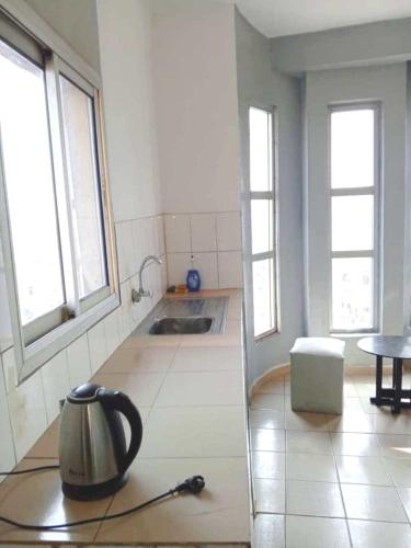 una cucina con un bollitore per il tè sul pavimento di Cybhouse a Yaoundé
