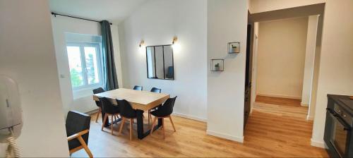 une salle à manger avec une table et des chaises et une fenêtre dans l'établissement 2 en 1, 10 pers, parking, Wifi, à Clermont-Ferrand