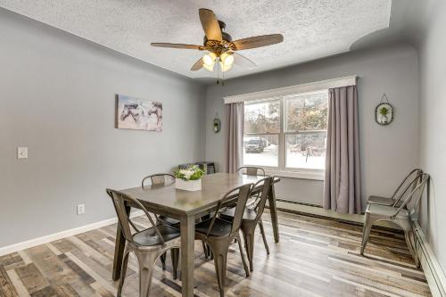 a dining room with a table and chairs and a ceiling fan at Charming Curtis House Large Deck with Lake View! in Curtis