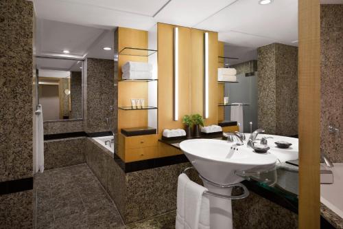 a bathroom with a sink and a shower and a toilet at Westin Josun Seoul Hotel in Seoul
