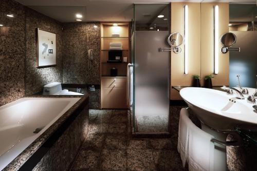 a bathroom with a tub and a sink and a shower at Westin Josun Seoul Hotel in Seoul