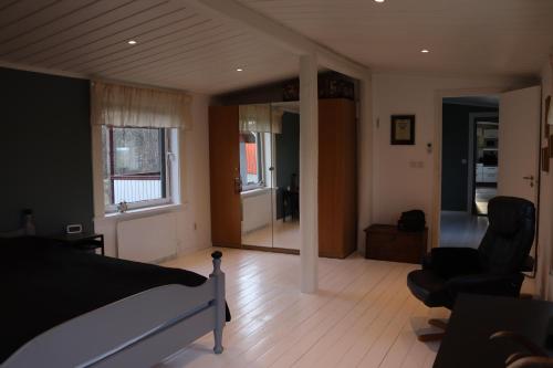 a bedroom with a bed and a living room at Bäckens Guesthouse in Älgarås