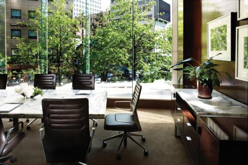 an office with a table and chairs and a large window at Westin Josun Seoul Hotel in Seoul