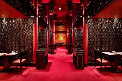 a dining room with tables and chairs and red lighting at Westin Josun Seoul Hotel in Seoul