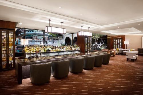 a bar in a hotel with a row of chairs at Westin Josun Seoul Hotel in Seoul