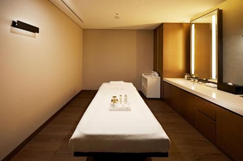 a large room with a bed and a sink at Westin Josun Seoul Hotel in Seoul