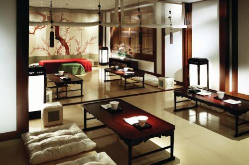 a living room with tables and a couch at Westin Josun Seoul Hotel in Seoul