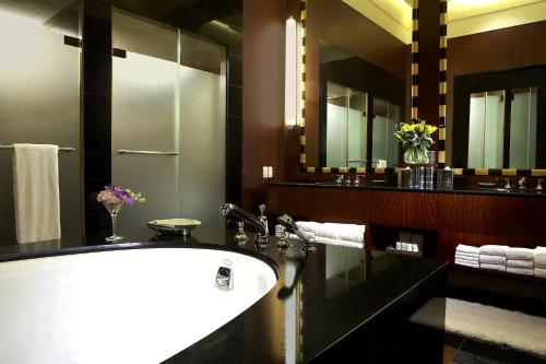 a bathroom with a tub and a large mirror at Westin Josun Seoul Hotel in Seoul