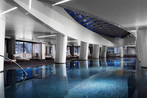 a swimming pool in a building with a blue floor at Westin Josun Seoul Hotel in Seoul