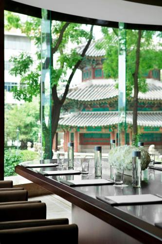 a long table with glasses and chairs in front of a building at Westin Josun Seoul Hotel in Seoul