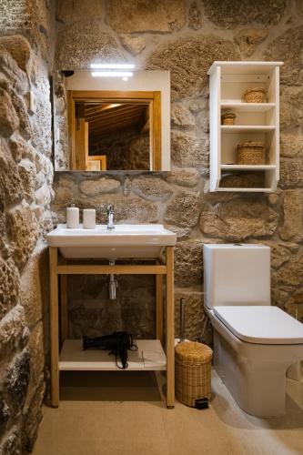 a bathroom with a sink and a toilet at Quinta da Portela - Casa Visconde Arneiros - by RowdHouses in Lamego