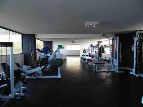 a room with a gym with a motorcycle on display at Apartamento em Praia de Cotovelo in Parnamirim