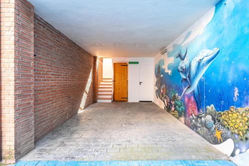 a hallway with a mural on the wall at Can Prats in Ríudecañas
