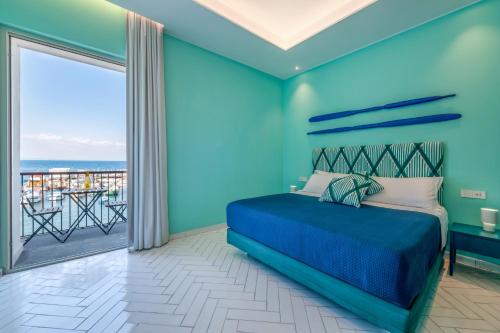 a blue bedroom with a bed and a balcony at Blasi Sea View in Sorrento