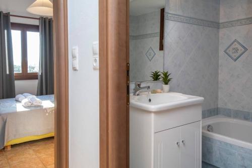 a bathroom with a sink and a bath tub at Zoe & Zen Collection in Kampos Paros