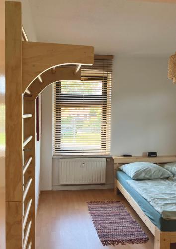 a bedroom with a bunk bed and a window at FEWO mit Sauna & Gartenblick in Neustadt in Sachsen