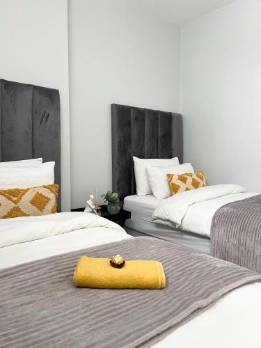 a yellow towel sitting on top of two beds at C&J city centre Airbnb in Windhoek