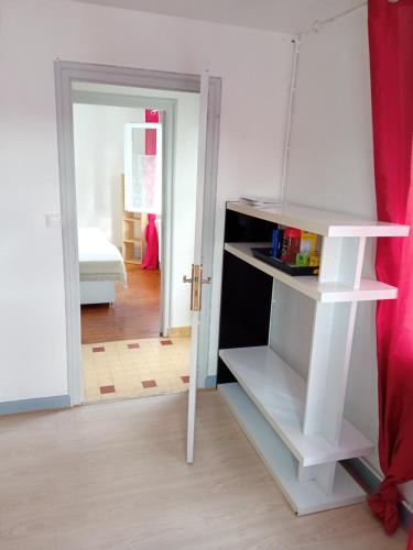 a room with a white book shelf and a mirror at gite D ETAPE DU PELERIN de la butte aux oiseaux in Saint-Alban-sur-Limagnole