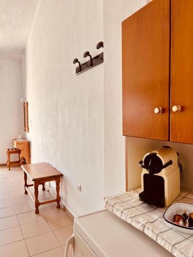 a kitchen with a counter with a toaster on the counter at Lenio Rooms in Skiathos Town