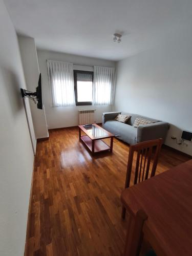 a living room with a couch and a table at Estudio Céntrico F3 in Oviedo
