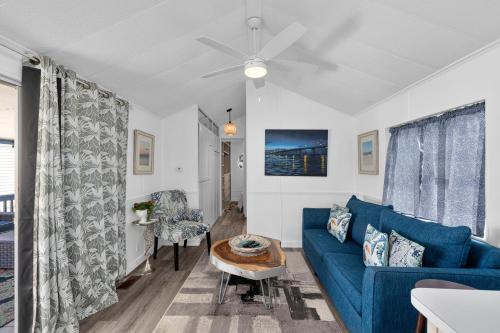 a living room with a blue couch and a table at LIV Resort, Private Jacuzzi and Pet Friendly in Port Isabel