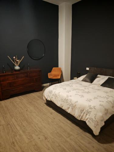 a bedroom with a bed and a dresser and a mirror at Isensi Luxury Suite Trani in Trani