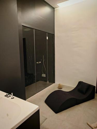 a bathroom with a sink and a shower at Isensi Luxury Suite Trani in Trani