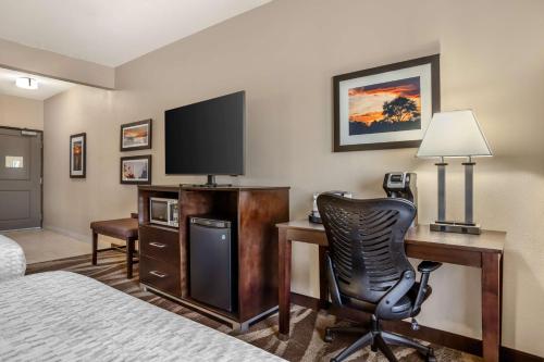 a hotel room with a desk with a computer and a chair at Best Western Plus Lake Jackson Inn & Suites in Lake Jackson