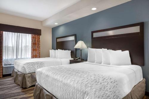 a hotel room with two beds and a window at Best Western Plus Lake Jackson Inn & Suites in Lake Jackson