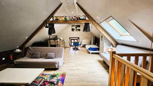 a living room with a couch and a loft at Gîte de France Les mésanges 3 épis - Gîte de France 4 personnes MAE-9904 in Saint-Augustin