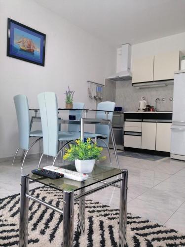 a living room with a glass table and chairs at Studio apartman Pepi in Stinica
