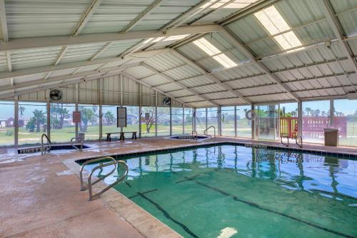 a large indoor swimming pool with an open ceiling at LIV Resort, Private Jacuzzi and Pet Friendly in Port Isabel