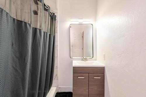 a bathroom with a sink and a mirror at Phoenix Red Room for Couples in Phoenix