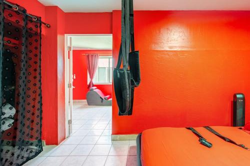 a red room with a bed and a red wall at Phoenix Red Room for Couples in Phoenix