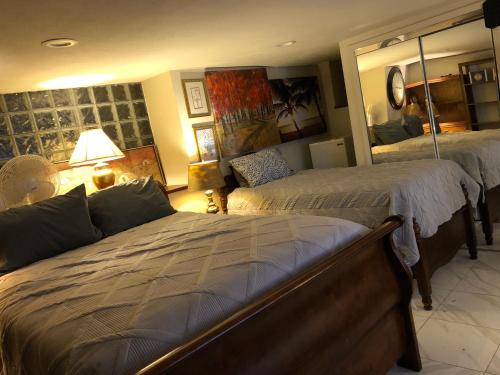 a bedroom with two beds and a large mirror at Highland Park Pittsburgh in Pittsburgh