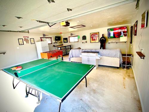 a living room with a ping pong table in it at Green Bay Packer Game House or Resch Expo less than 1 mile from Lambeau Field in Green Bay