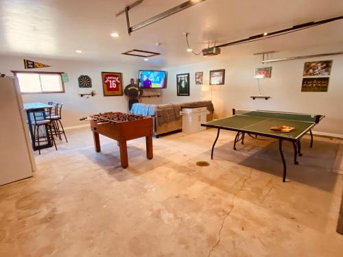 a living room with a ping pong table and a couch at Green Bay Packer Game House or Resch Expo less than 1 mile from Lambeau Field in Green Bay