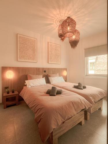 a bedroom with a large bed with two pillows on it at Résidence Alissa Charleroi Airport in Charleroi