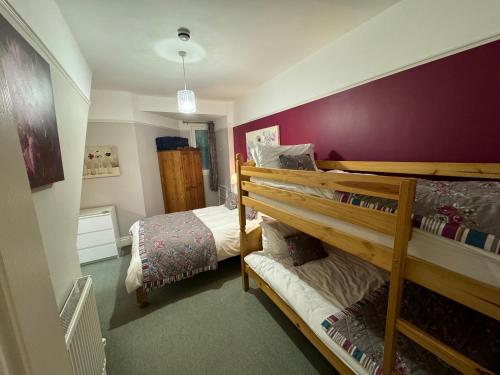 a bedroom with two bunk beds and a bed at Hargate Hall Self Catering in Buxton