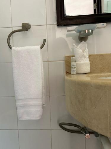 a bathroom with a sink and a white towel at Hotel Marcianito in Isla Mujeres